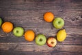 Oranges apples and lemon on wooden background Royalty Free Stock Photo