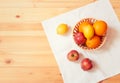 Oranges, apples and lemons in basket on white napkin on table. Top view, copy space Royalty Free Stock Photo
