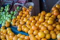 Oranges and apples spilling from baskets outside a Paris market