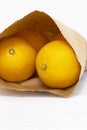 Oranges in a brown paper bag. Environmentally friendly packaging concept