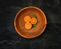 The oranges citrus fruit halves on wooden plate