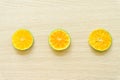 Oranges cut in half on a wooden background, free space