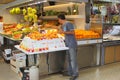 Worker at the market with oranges and fresh fruit juices, a specialty of Valencia, Spain Royalty Free Stock Photo