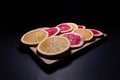 Oranges fruit on black wooden boards. Halves of juicy orange on black background. Orange fruit, citrus minimal concept. Top view, Royalty Free Stock Photo