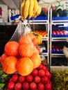 Oranges in fruit shop market bunch of healthy juicy fruits with yellow banana hanging on the top Royalty Free Stock Photo