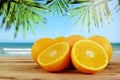 Oranges fruit on wooden table and blur beach background. Royalty Free Stock Photo