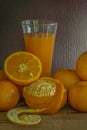 Oranges and glass of juice on a wooden table. / Still life fruit.