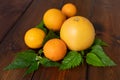 Oranges and grapefruit on a brown wooden background, top view, text space, citrus Royalty Free Stock Photo