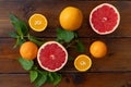 Oranges and grapefruit on a brown wooden background, top view, text space, citrus Royalty Free Stock Photo