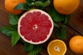 Oranges and grapefruit on a brown wooden background, top view, text space, citrus Royalty Free Stock Photo