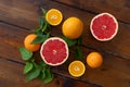 Oranges and grapefruit on a brown wooden background, top view, text space, citrus Royalty Free Stock Photo