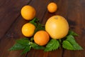 Oranges and grapefruit on a brown wooden background, top view, text space, citrus Royalty Free Stock Photo