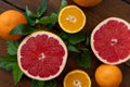 Oranges and grapefruit on a brown wooden background, top view, text space, citrus Royalty Free Stock Photo