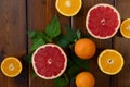 Oranges and grapefruit on a brown wooden background, top view, text space, citrus Royalty Free Stock Photo