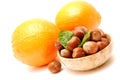 Oranges and hazelnuts in a marble bowl