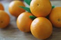 A few oranges with a heart aign made of close seeds in a gray bowl closeup on an old wooden backdround in brown with a blurred bac Royalty Free Stock Photo