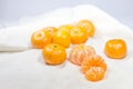 Oranges fruit arranged on white fabric as background. Royalty Free Stock Photo