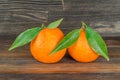 Oranges with leaves on wood