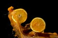 Oranges and orange juice splash on a black background