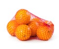 Oranges in plastic mesh sack Royalty Free Stock Photo