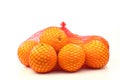 Oranges in a red plastic net Royalty Free Stock Photo