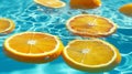 Oranges sliced floating in blue water surface in swimming pool and sunshine, vitamin c, healthy food, cosmetic, fashion, skin care Royalty Free Stock Photo