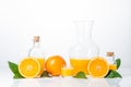 Oranges, oranges slices, orange leaves, and glass containers with orange juice isolated on white background Royalty Free Stock Photo