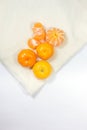 The fresh oranges fruit are arranged on a white cloth background. Royalty Free Stock Photo