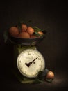 Oranges, tangerines on scales on rustic hessian. Dark, chiaroscuro style still life. Vintage theme. Vertical shot. Royalty Free Stock Photo