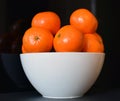 Oranges in white bowl with a black background Royalty Free Stock Photo