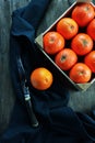 Oranges in wooden fruit crate and a knife Royalty Free Stock Photo