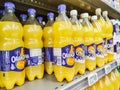 Orangina Soft drink bottle`s display for sell in french supermarket with selective focus