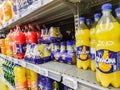 Orangina Soft drink bottle`s display for sell in french supermarket with selective focus