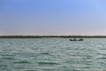 Fishermen in an old traditional fishing canoe near the island of Orango.