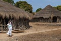 Mother carrying his small child on the back at the village of Eticoga in the island of Orango.