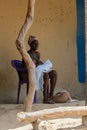 Unidentified local woman sits on the plastic chair in the Etigo