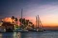 Oranjestad Aruba seen at sunset with boats, ocean and palm trees Royalty Free Stock Photo