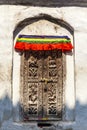 Orante carved wooden door with horse, chicken, pig and dog sculptures, Bodhnath Stupa, Kathmandu, Nepal