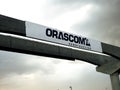 Orascom construction sign on Cairo monorail project which is under construction with a cloudy and rainy sky