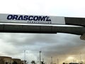 Orascom construction sign on Cairo monorail project which is under construction with a cloudy and rainy sky