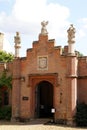 Orate arched entrance with statues and coat of arms Royalty Free Stock Photo