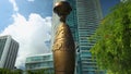 orbiting footage of the Egyptian Sphinx at Maurice A. Ferre Park with high rise hotels, skyscrapers and office buildings, lush