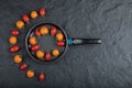 ORcanic Colorful cherry tomatoes in the pan on black background Royalty Free Stock Photo