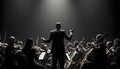 Orchestra Conductor Directing Musicians in Dramatic Black and White Lighting Royalty Free Stock Photo