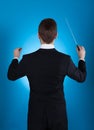 Orchestra conductor holding baton Royalty Free Stock Photo