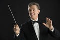 Orchestra Conductor Looking Away While Directing With His Baton Royalty Free Stock Photo