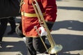 Orchestra member holds brass pipe. Trumpeter details. Ceremonial red uniform Royalty Free Stock Photo