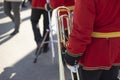 Orchestra member holds brass pipe. Trumpeter details. Ceremonial red uniform Royalty Free Stock Photo