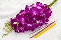 Orchid bouquet, a candle and three incense sticks to offer Buddhist monk or Buddha image Royalty Free Stock Photo