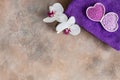 Orchid flower, aroma sea salt, natural cosmetic clay, and towel. Natural skin care. Spa kit for beauty and health. Close up, top